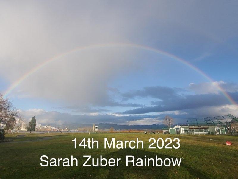 Rainbow over landscape symbolizing hope and support